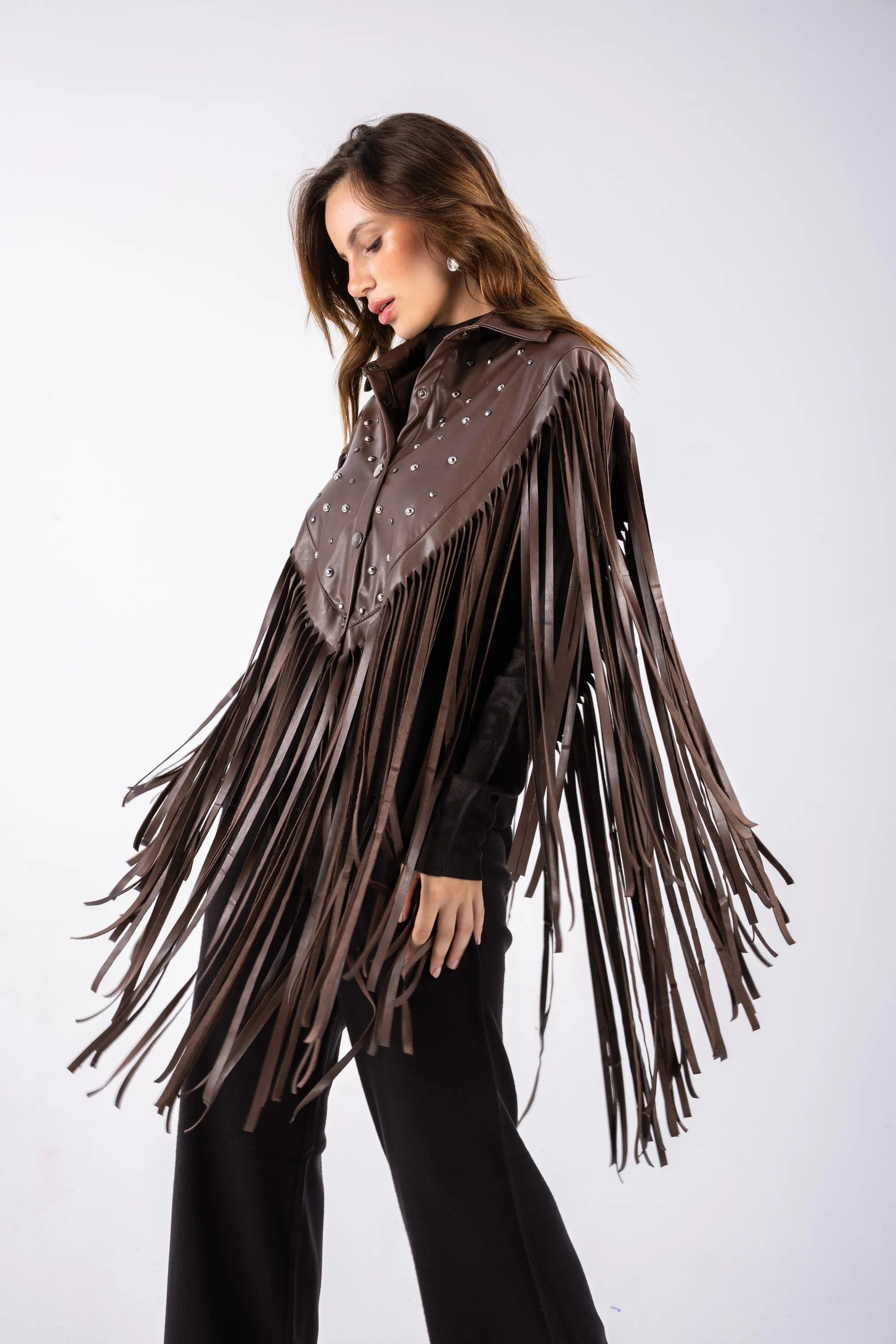 Woman wearing a brown fringe shirt on a white background