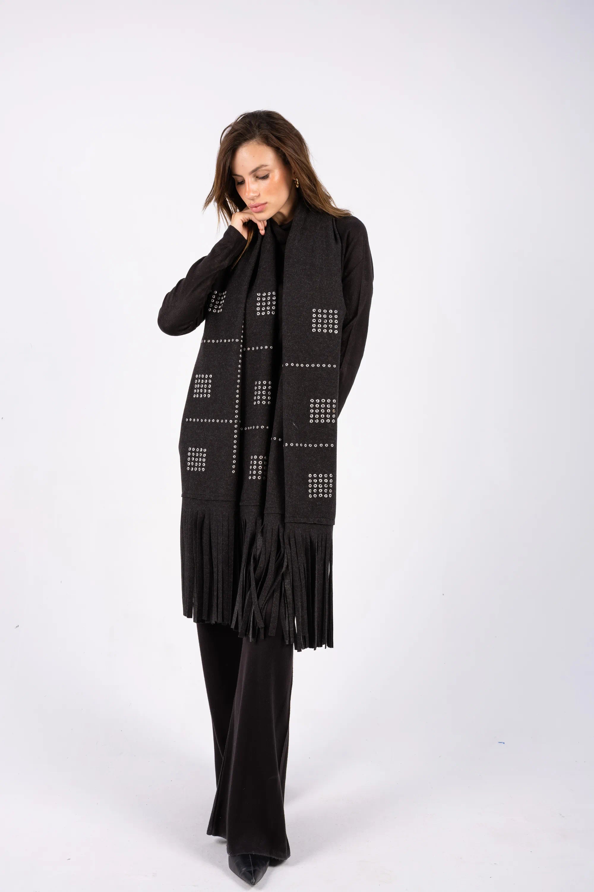 Woman wearing a black scarf with geometric patterns on a white background