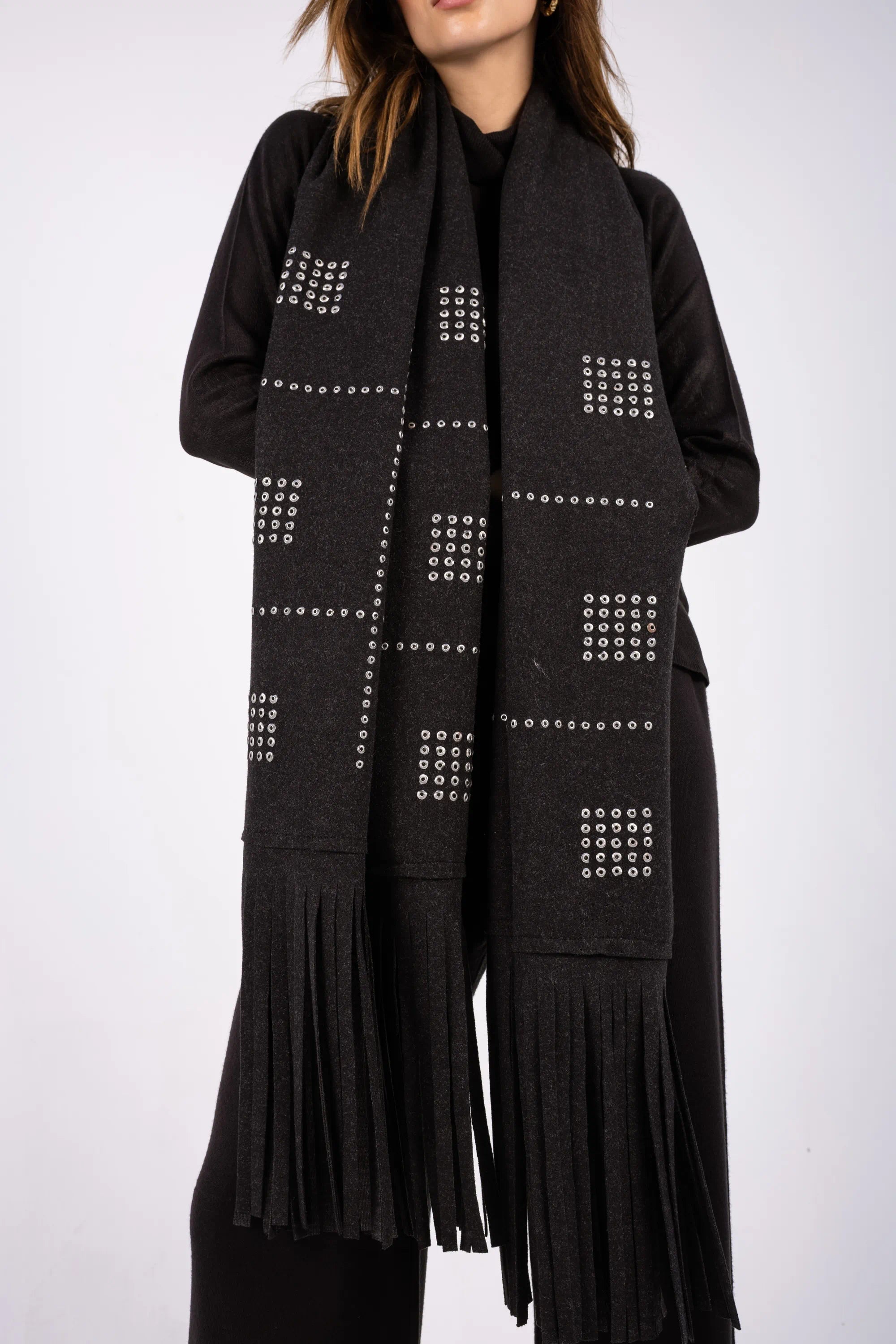 Black scarf with geometric pattern and fringes on a white background