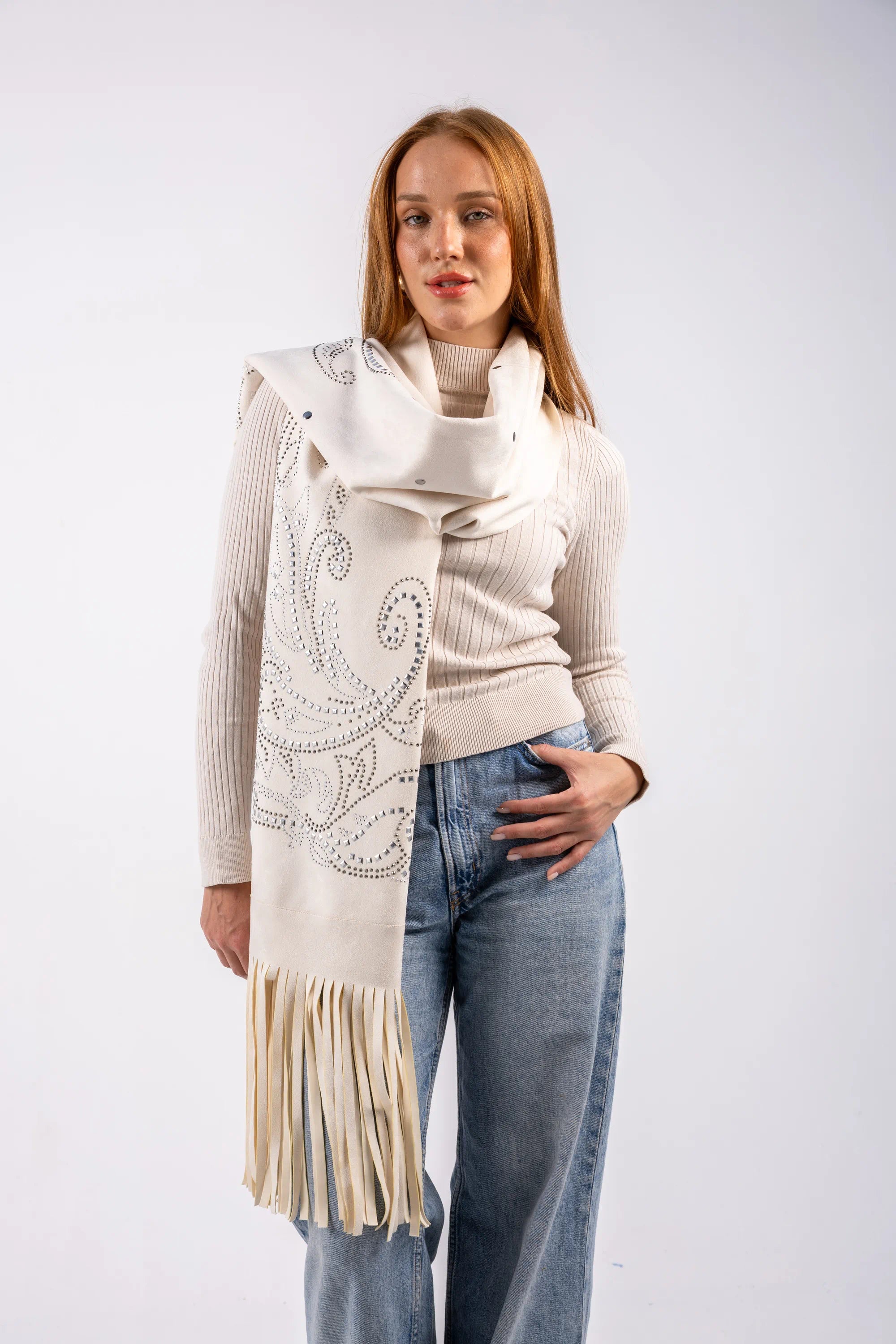 Woman wearing a cream-colored scarf with fringe on a white background