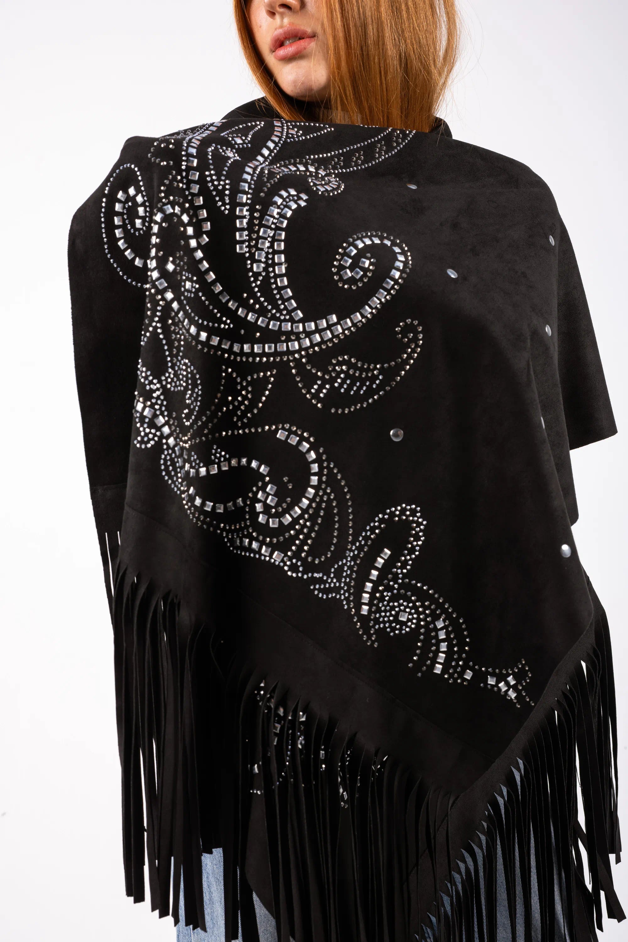 Black poncho with silver embellishments and fringes on a white background