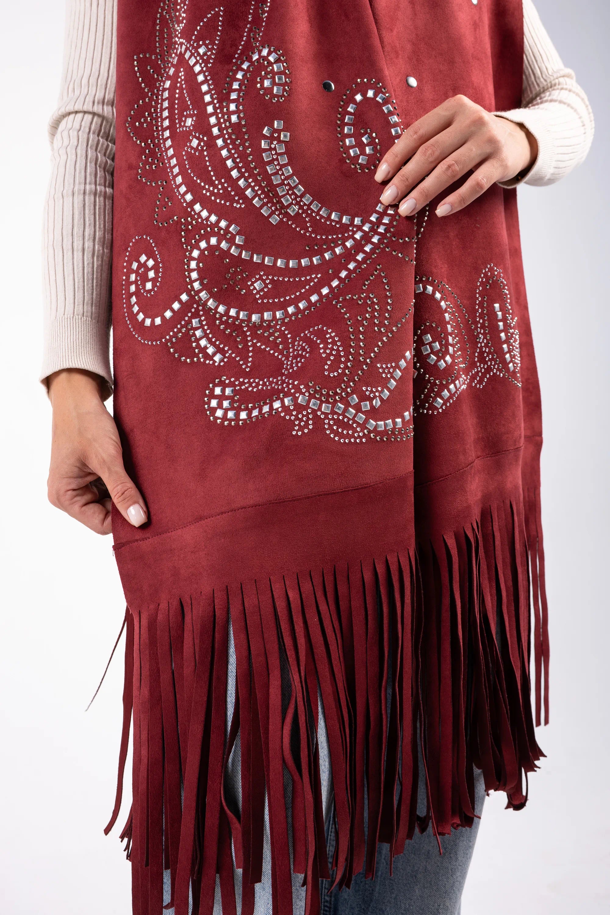 Red fringed scarf with white paisley patterns on a plain background