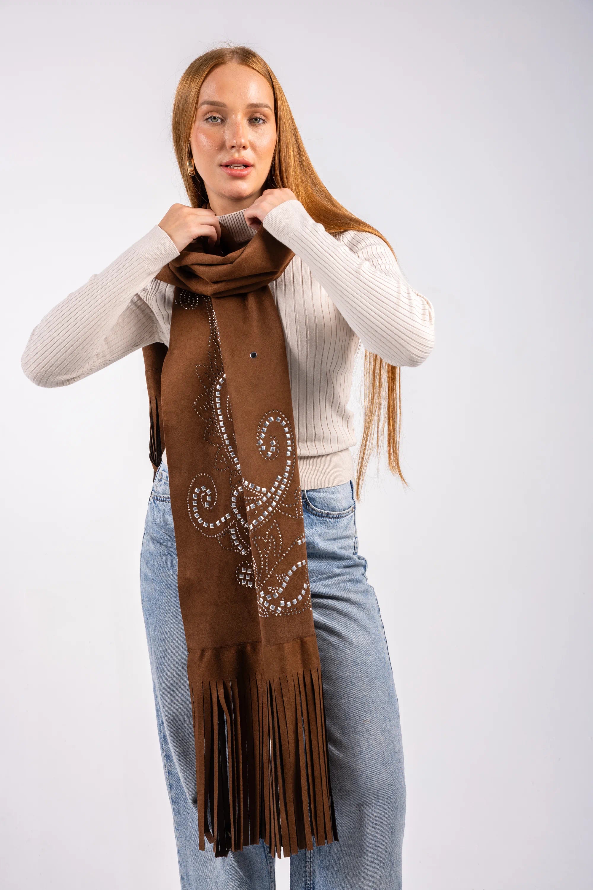 Woman wearing a brown scarf with decorative elements on a white background