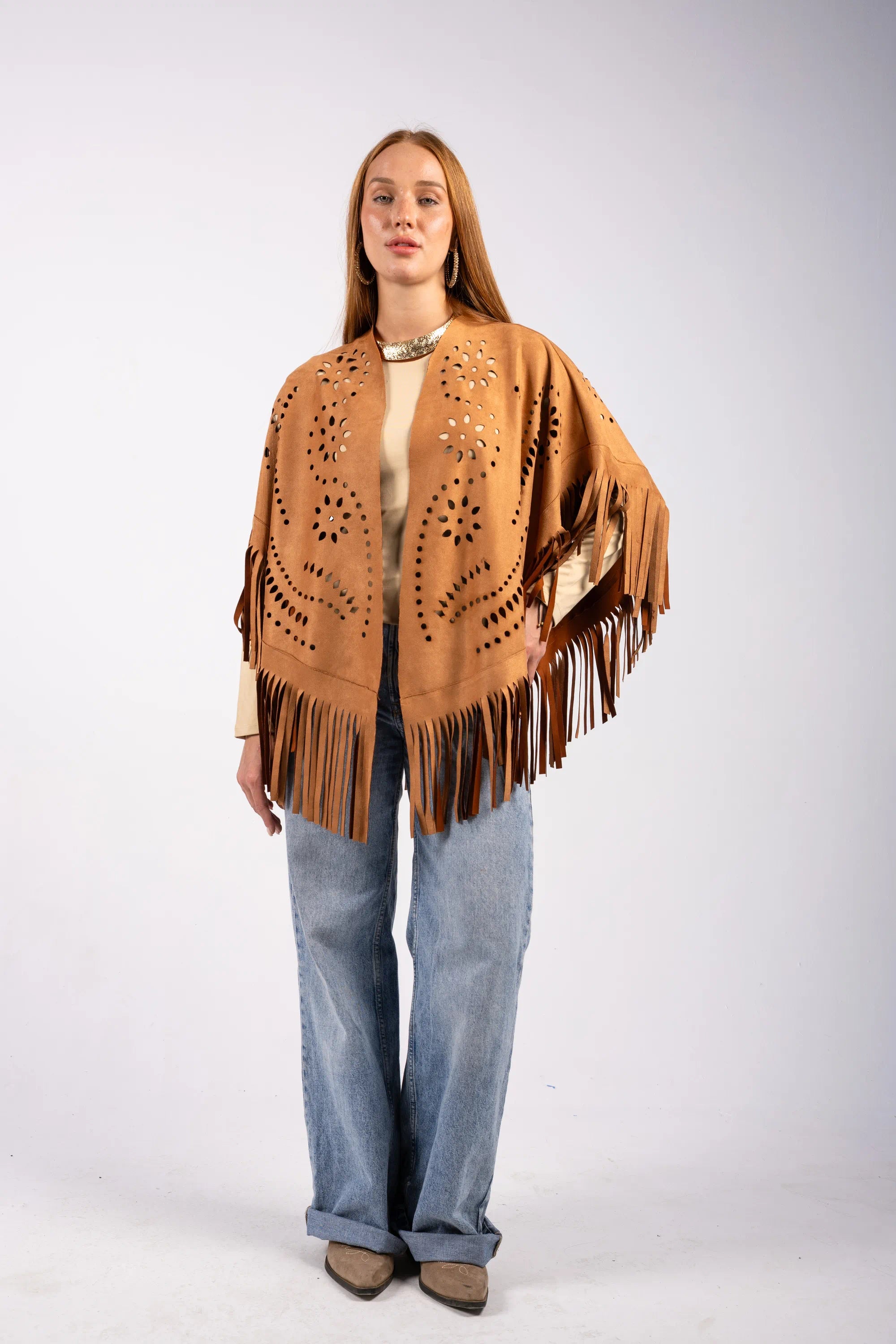 Woman wearing a brown fringe jacket on a white background