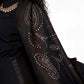Black garment with decorative patterns on a white background