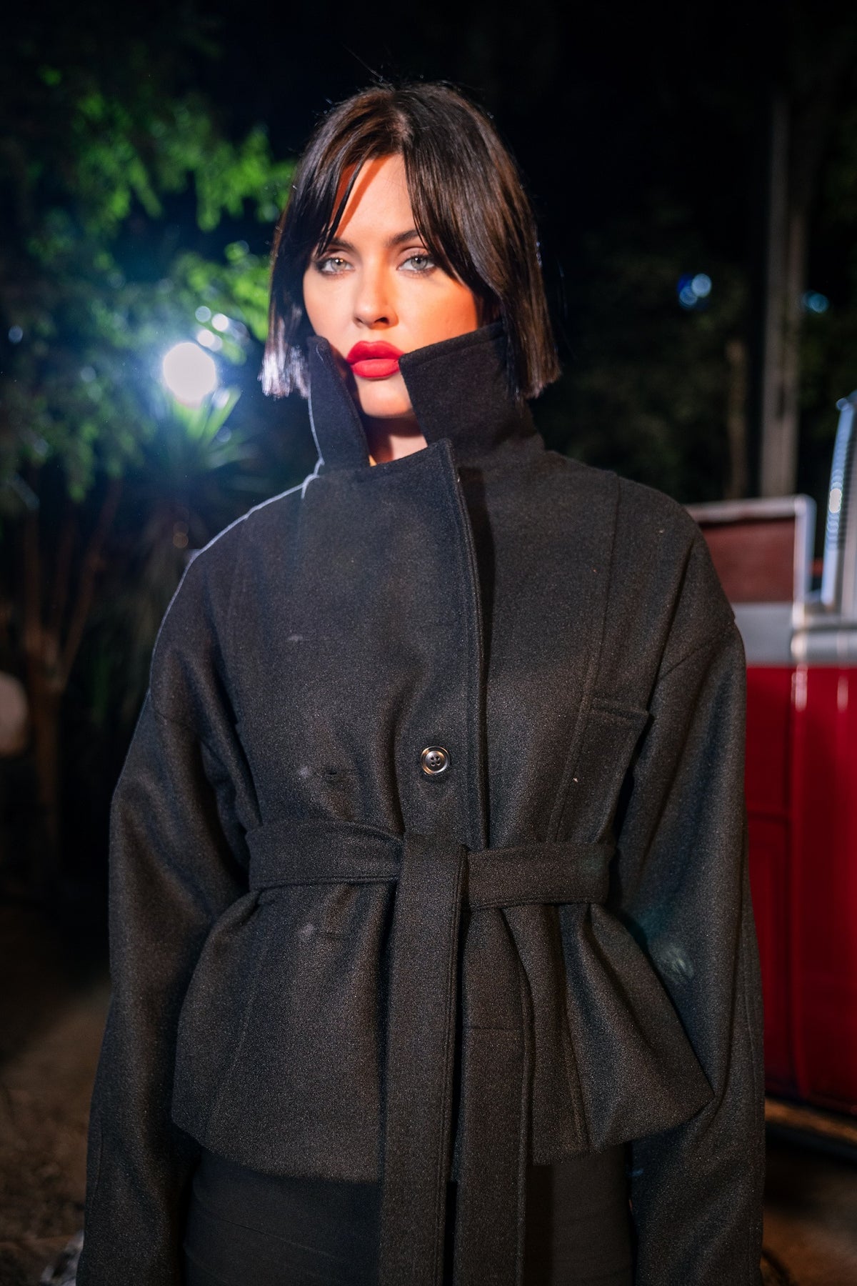 Person wearing a dark coat with a blurred background
