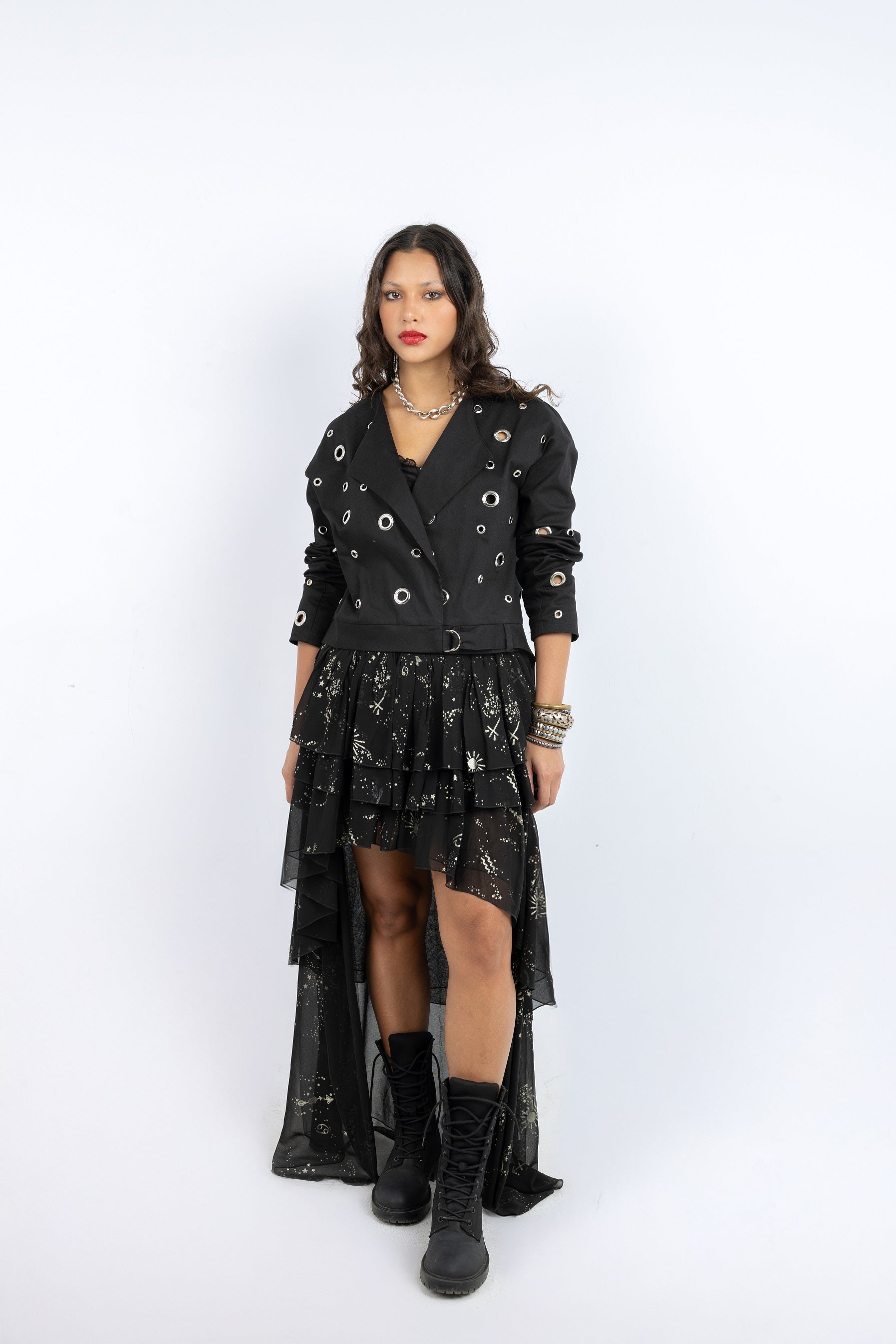 Woman wearing a black outfit with a jacket and skirt on a white background