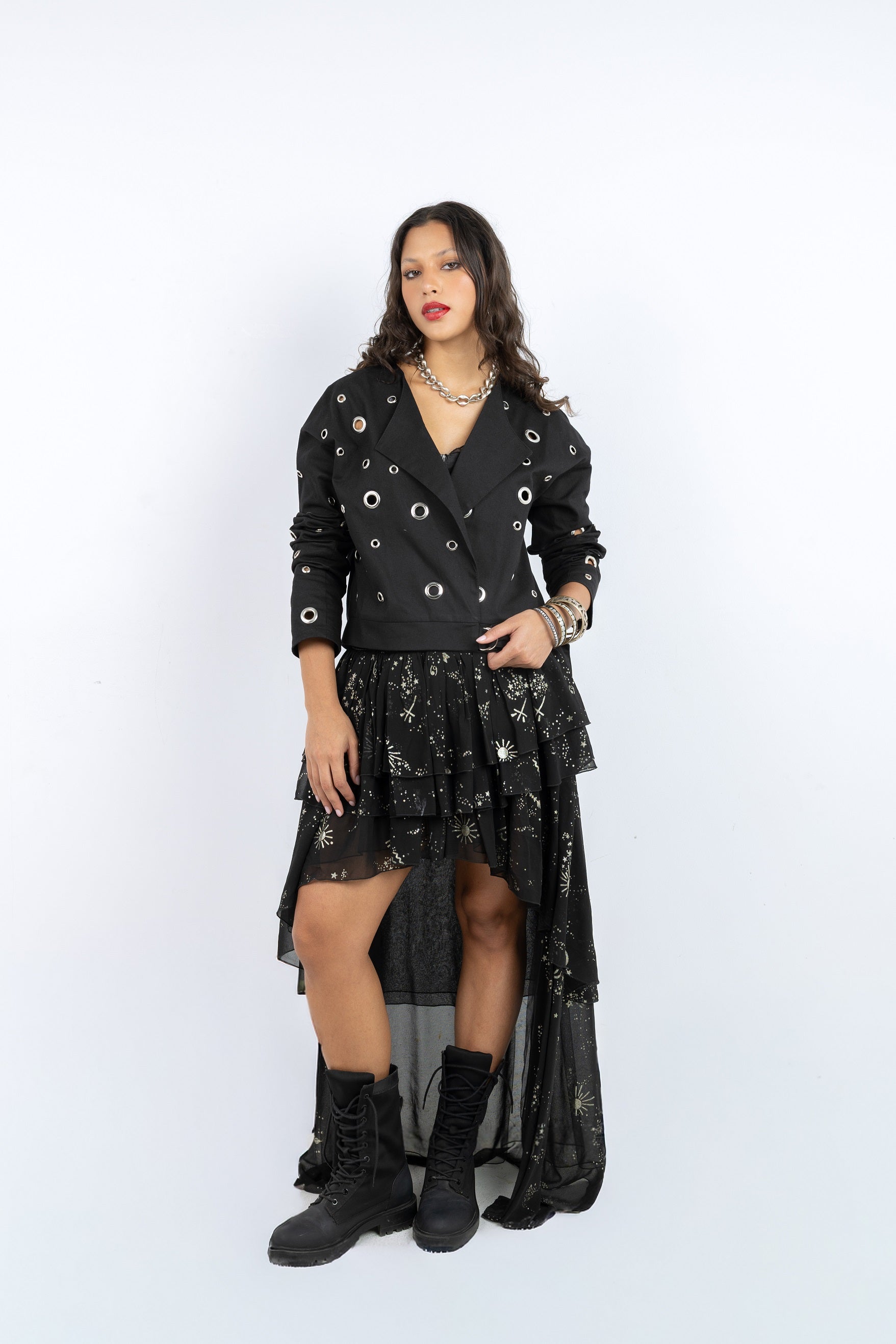 Woman wearing a black outfit with a jacket and skirt on a white background