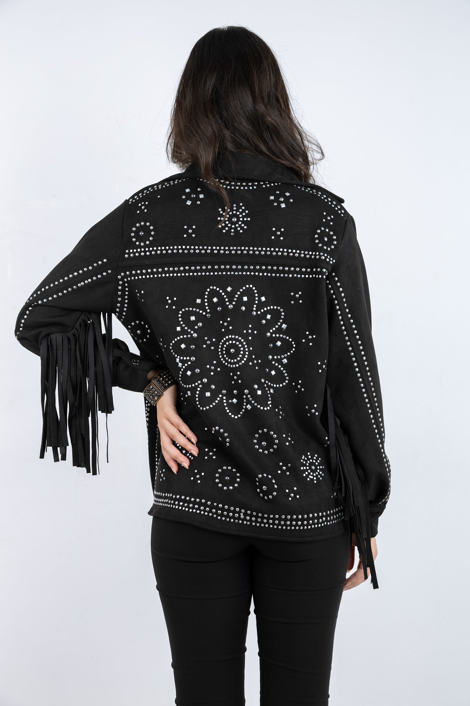 Black jacket with floral patterns and fringes on a white background