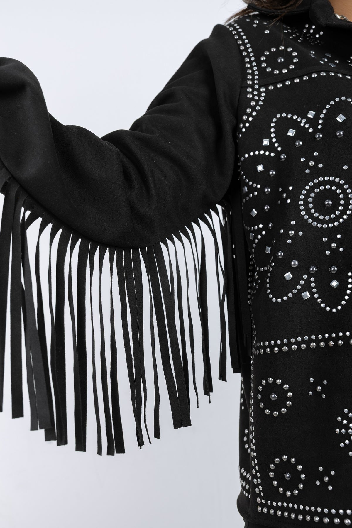 Black fringe jacket with rhinestone embellishments on a light gray background