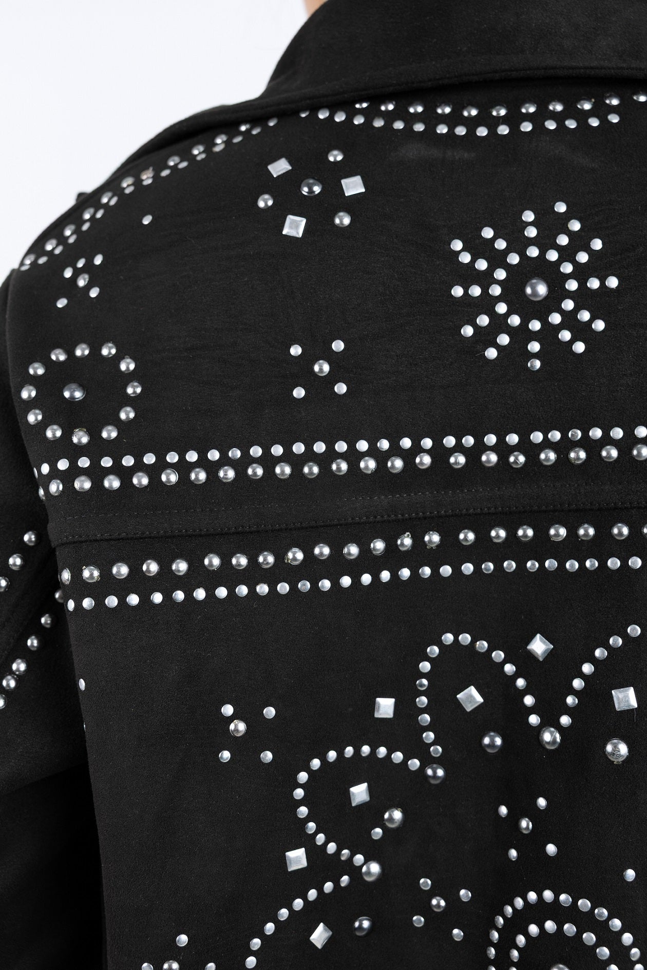 Black jacket with silver rhinestone embellishments on a plain background