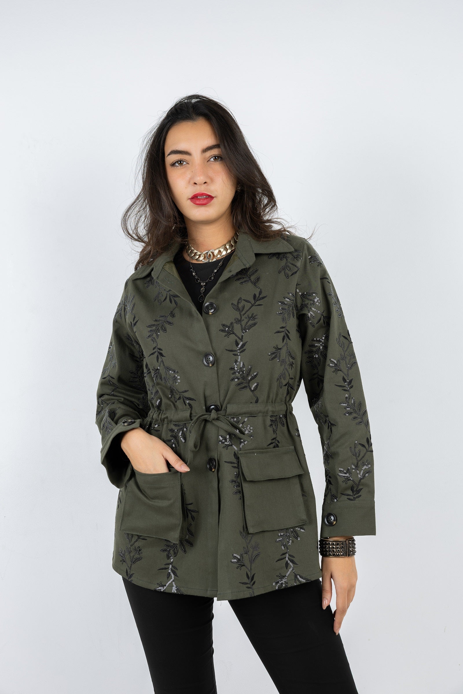 Woman wearing a green floral-patterned jacket on a white background