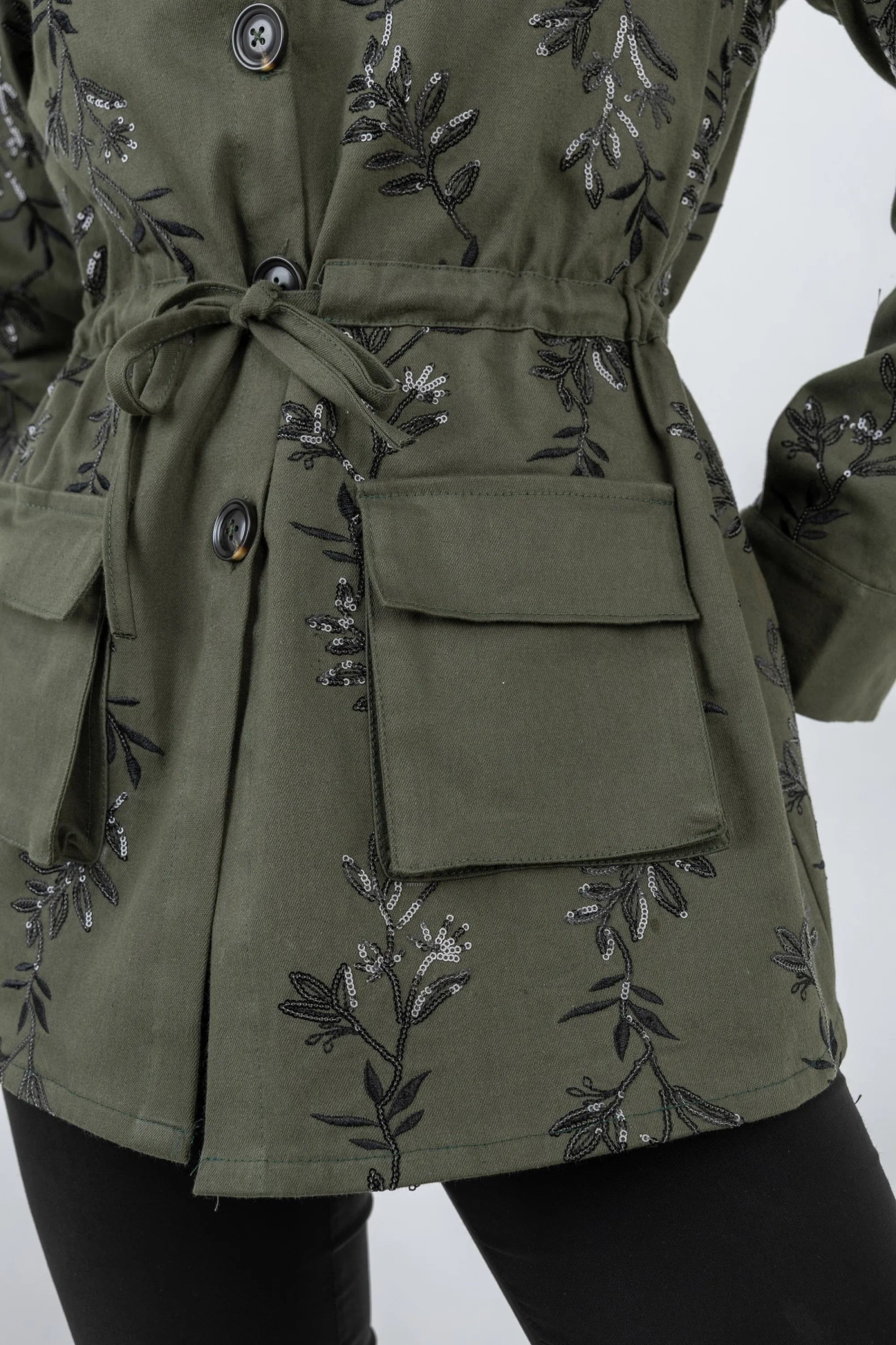 Green jacket with floral embroidery on a white background