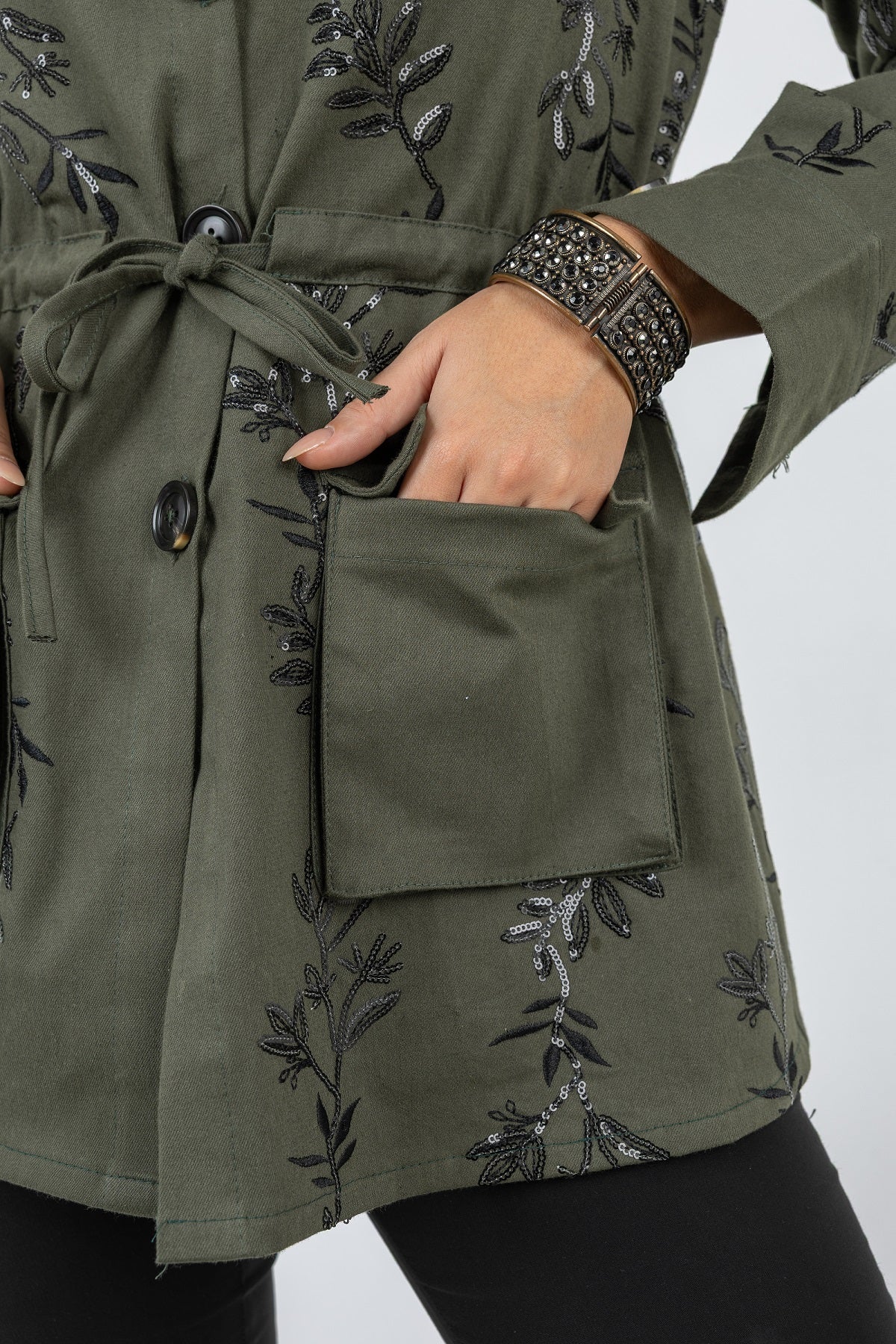 Green embroidered jacket with a pocket on a white background