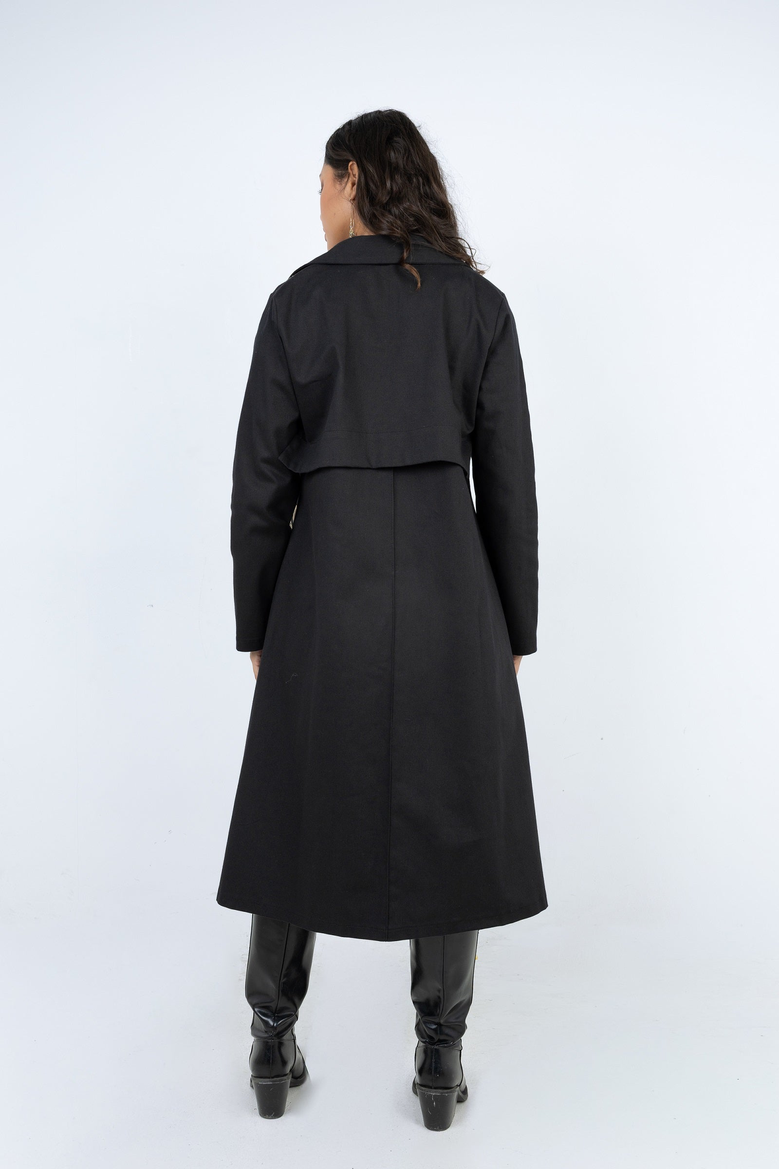 Person wearing a black coat on a white background