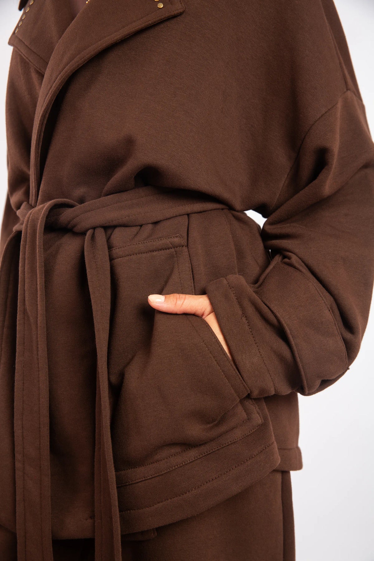 Brown coat with a belt on a white background