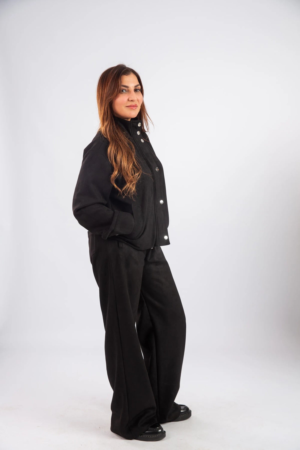 Person wearing a black outfit on a white background