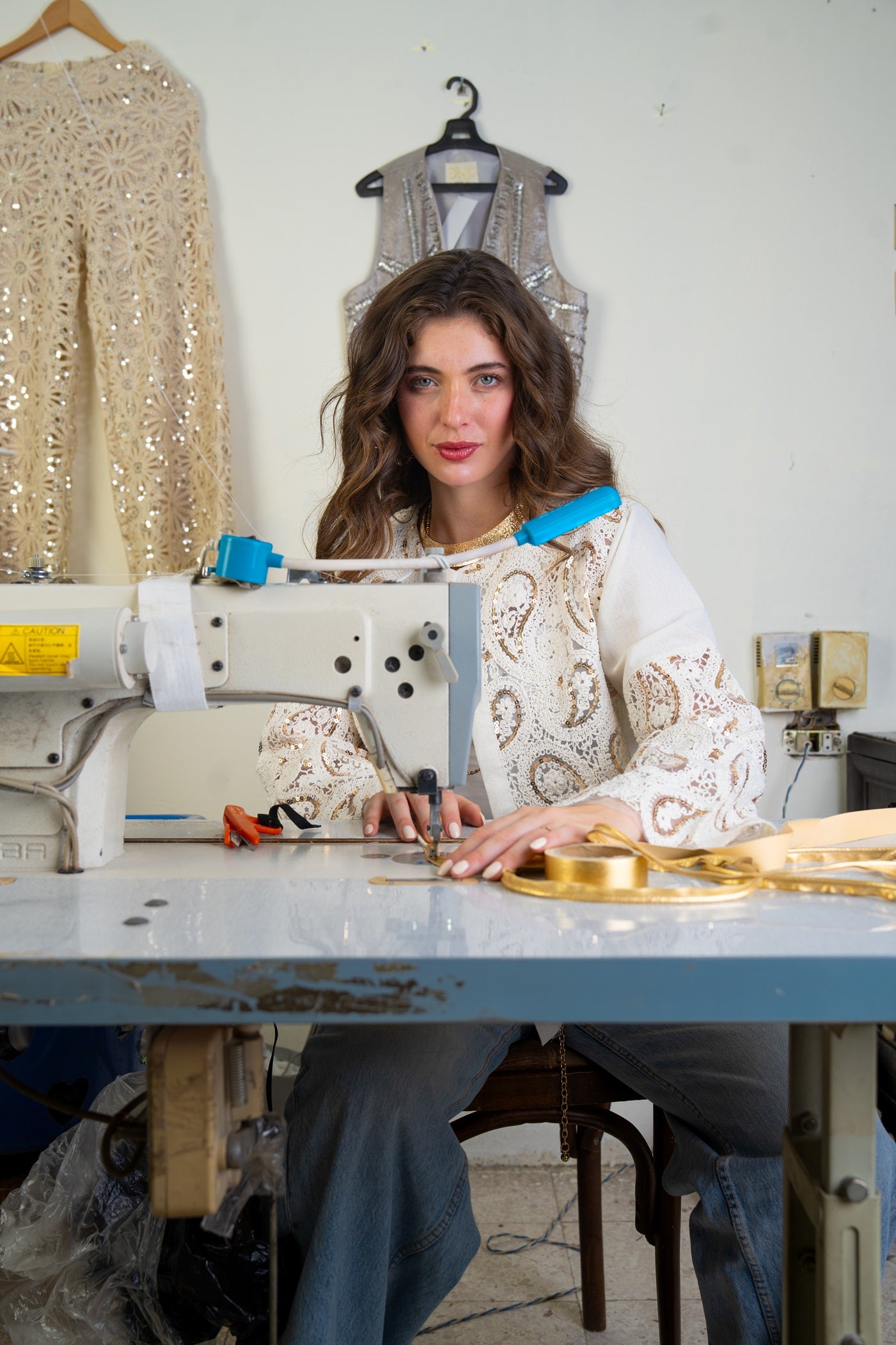 Woman working at a sewing machine in a workshop setting