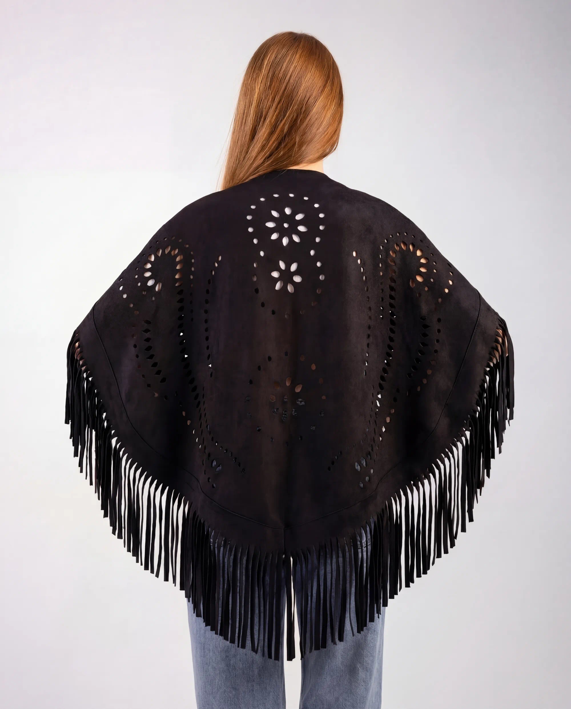Black fringe shawl worn by a person on a white background