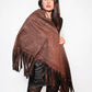 Woman wearing a brown fringed poncho against a white background