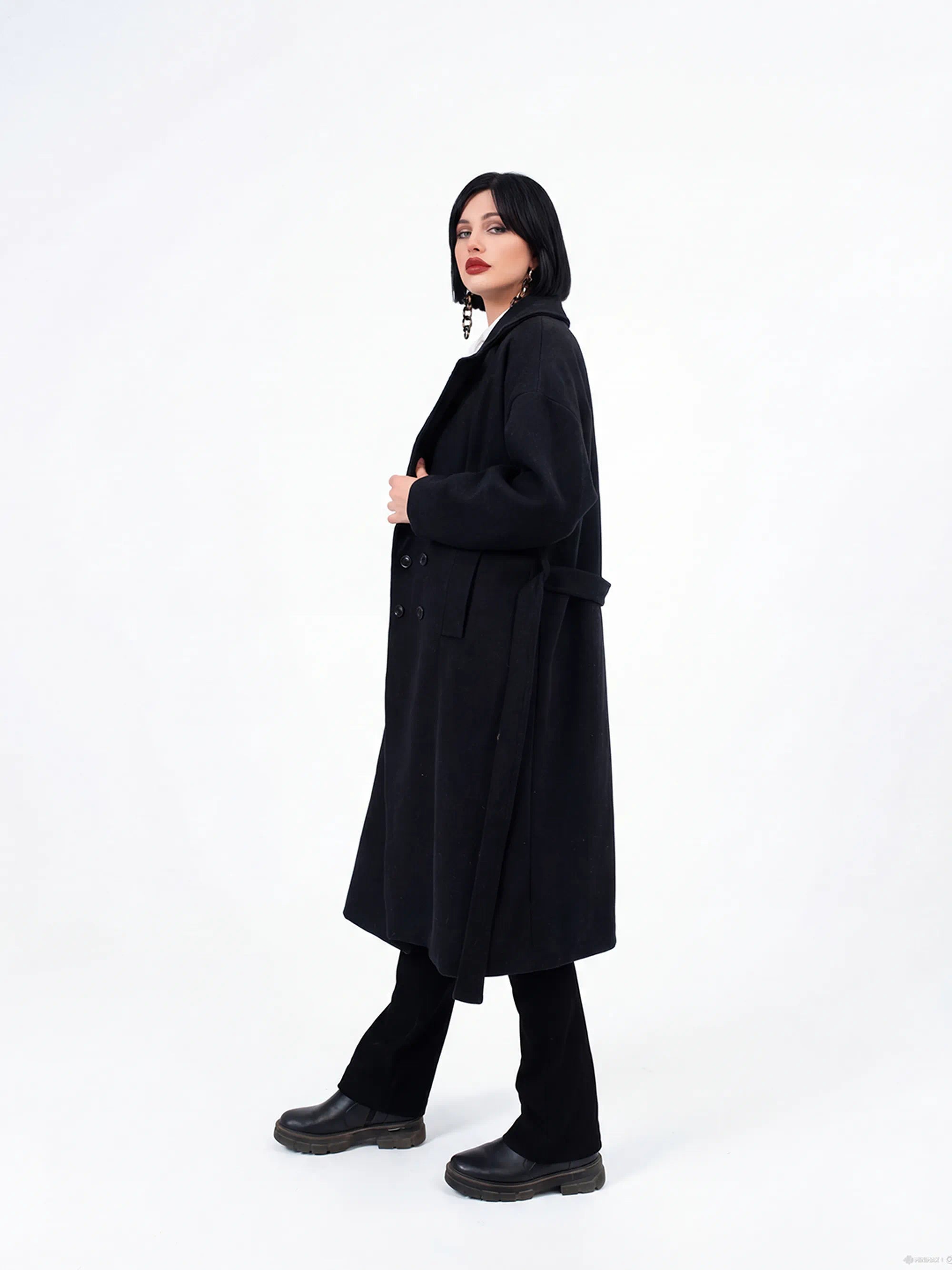 Person wearing a black coat on a white background