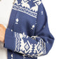 Navy blue sweater with white geometric pattern on a white background