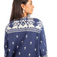 Woman wearing a navy blue sweater with white geometric patterns on a white background