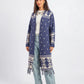 Woman wearing a blue patterned cardigan on a white background