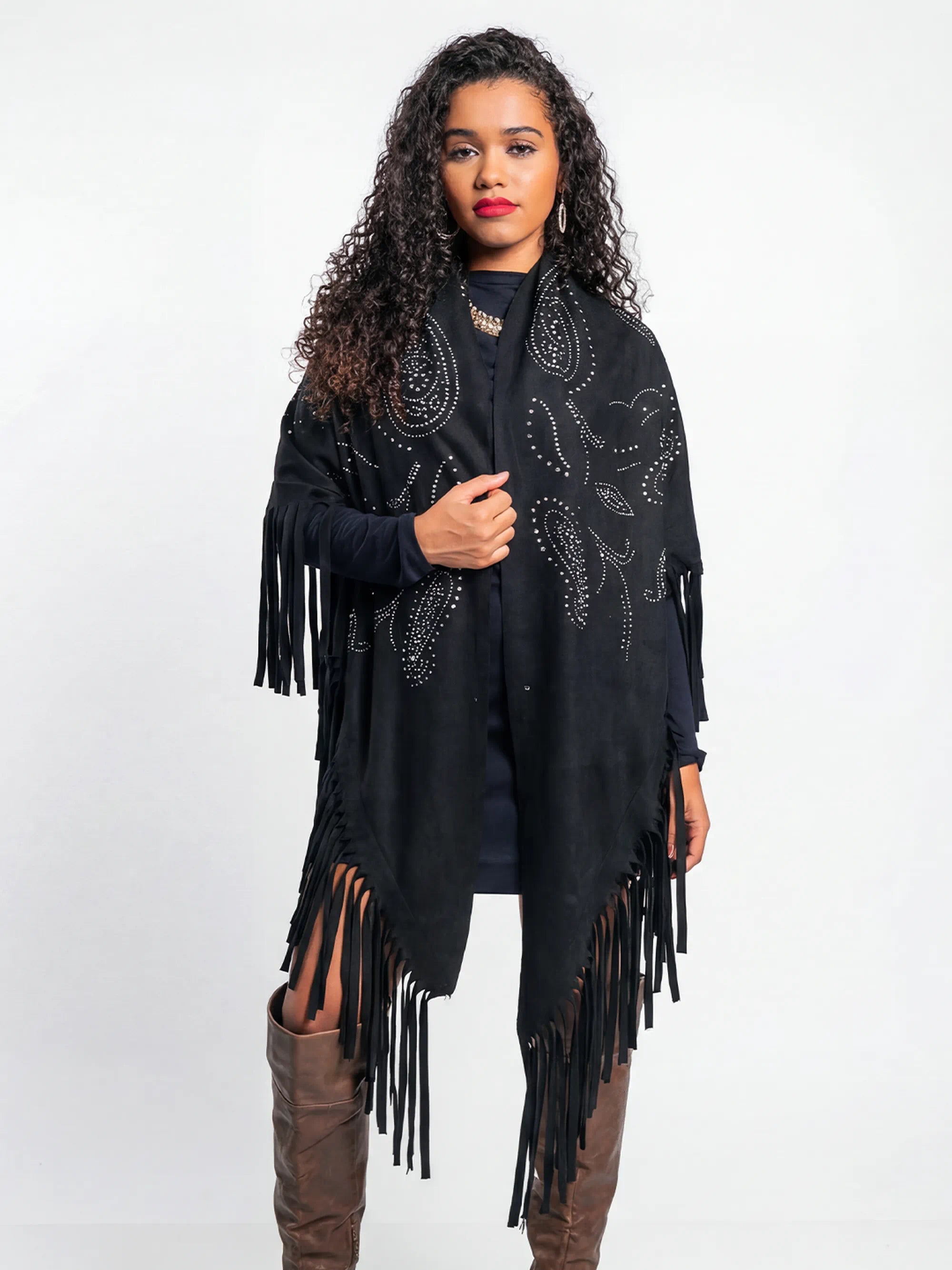 Woman wearing a black fringe poncho on a white background