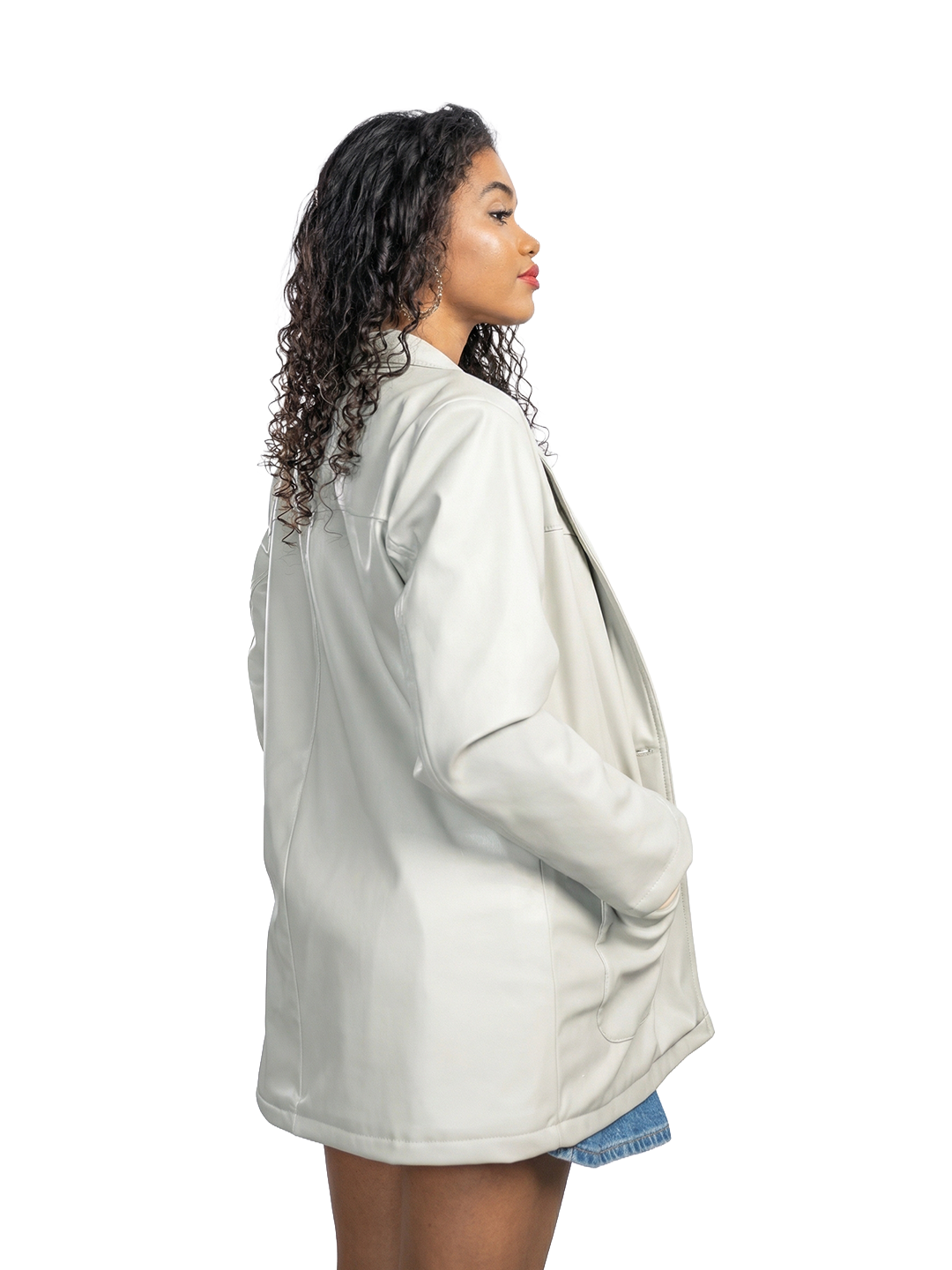 Person wearing a light gray oversized shirt on a white background