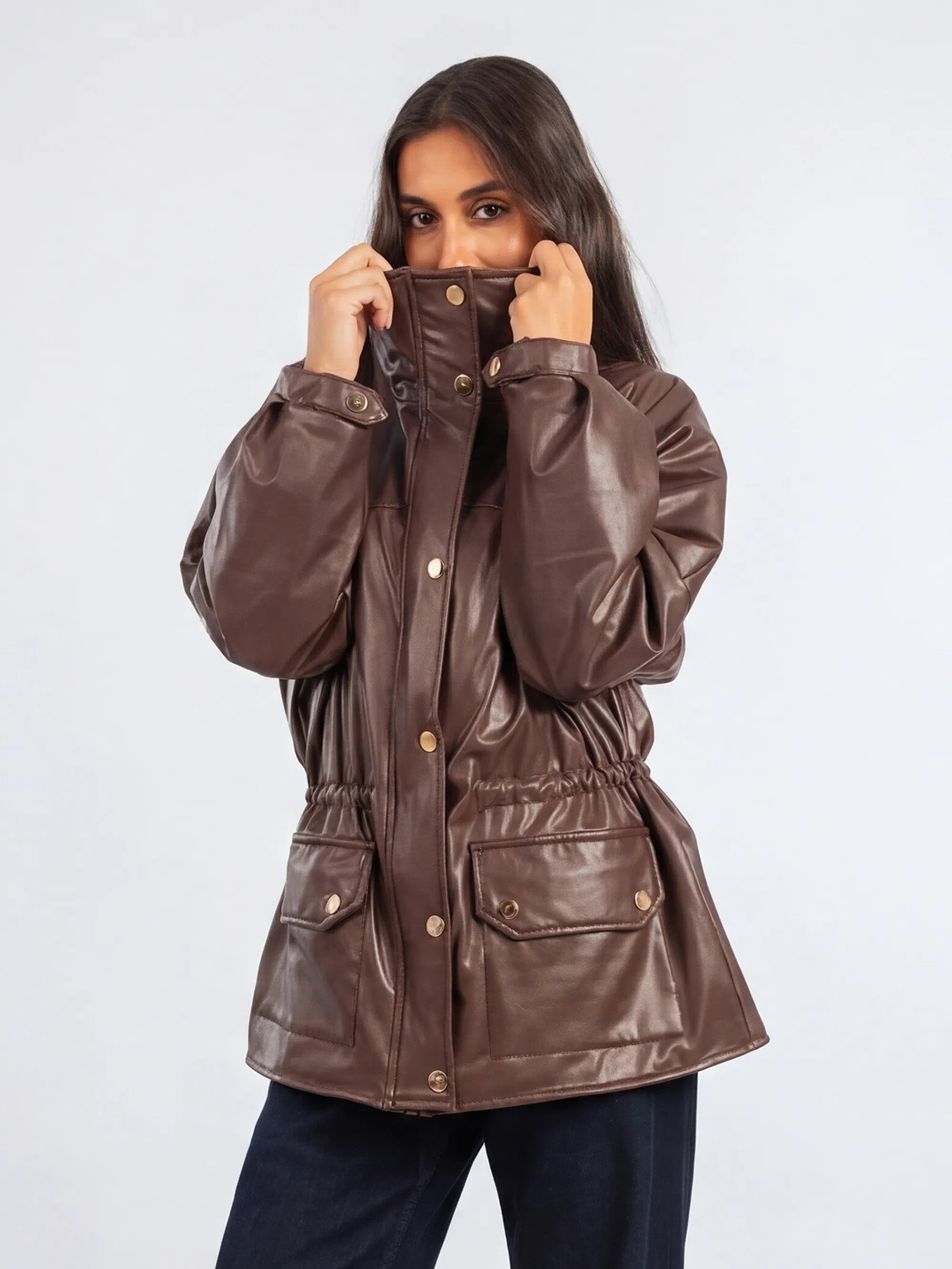 Woman wearing a brown raincoat on a white background