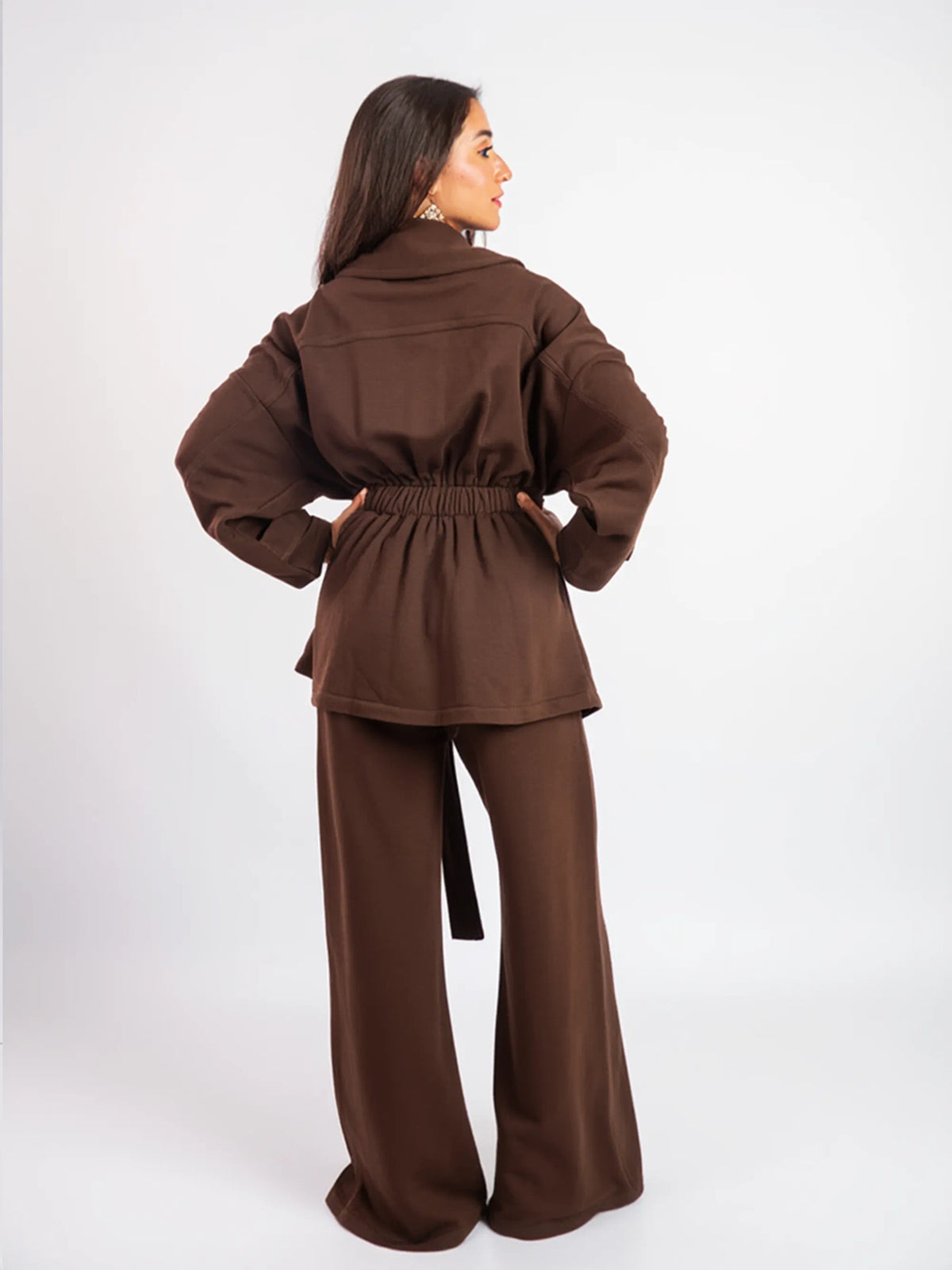 Woman wearing a brown outfit on a white background