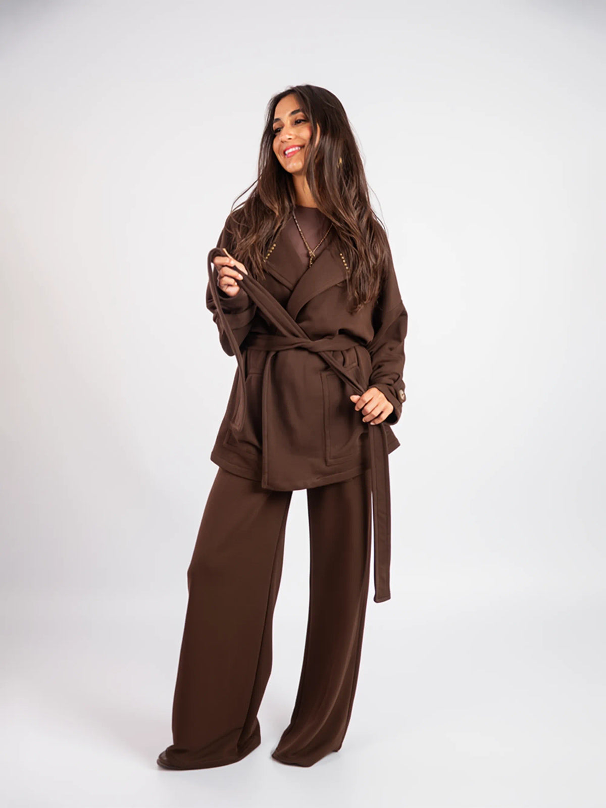 Woman wearing a brown outfit on a white background