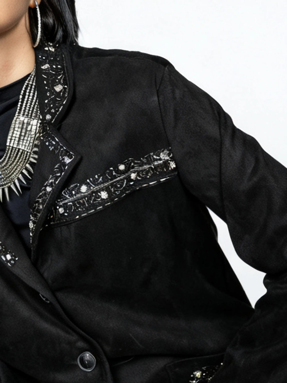 Black jacket with intricate silver embroidery on a white background