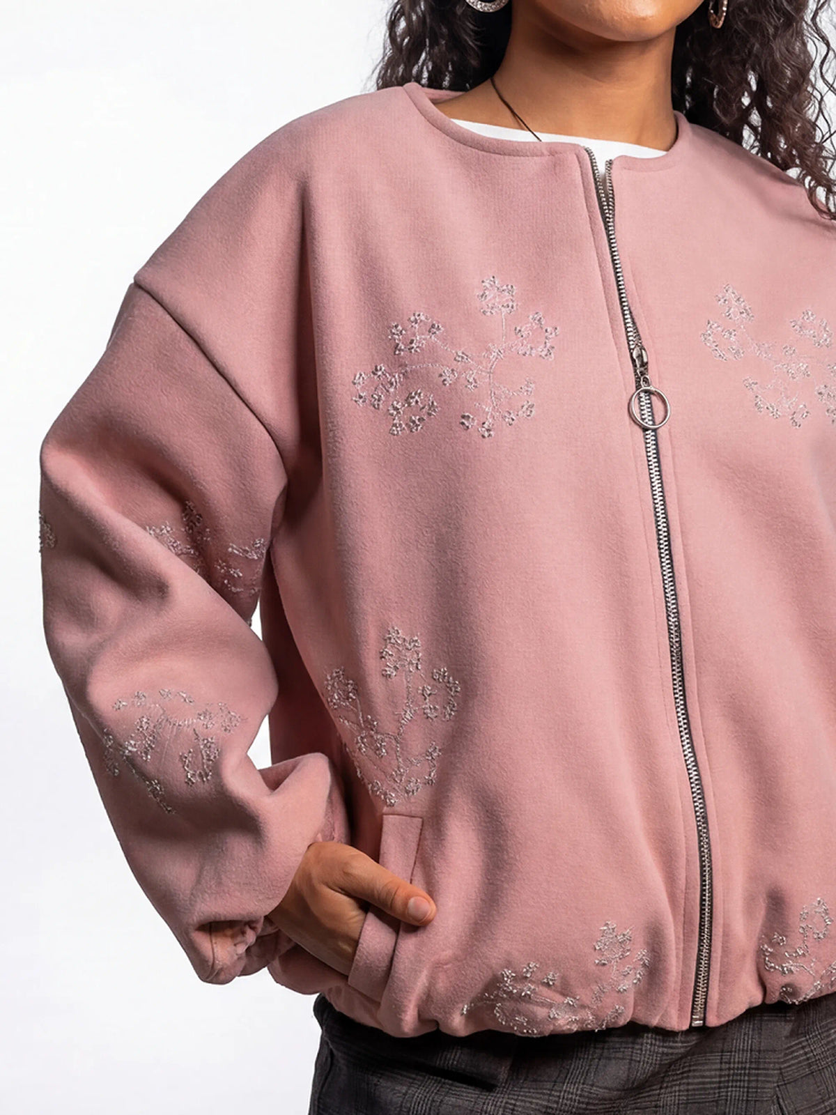 Pink bomber jacket with floral embroidery on a white background