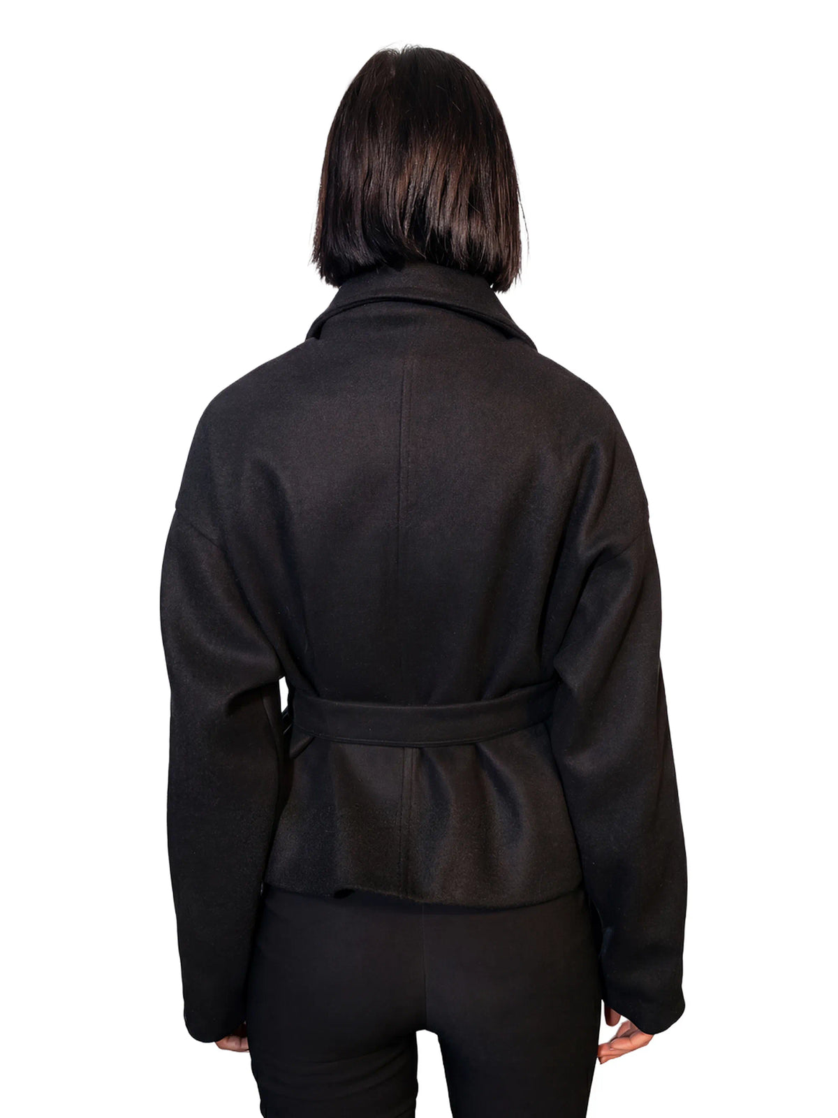 Person wearing a black jacket on a white background