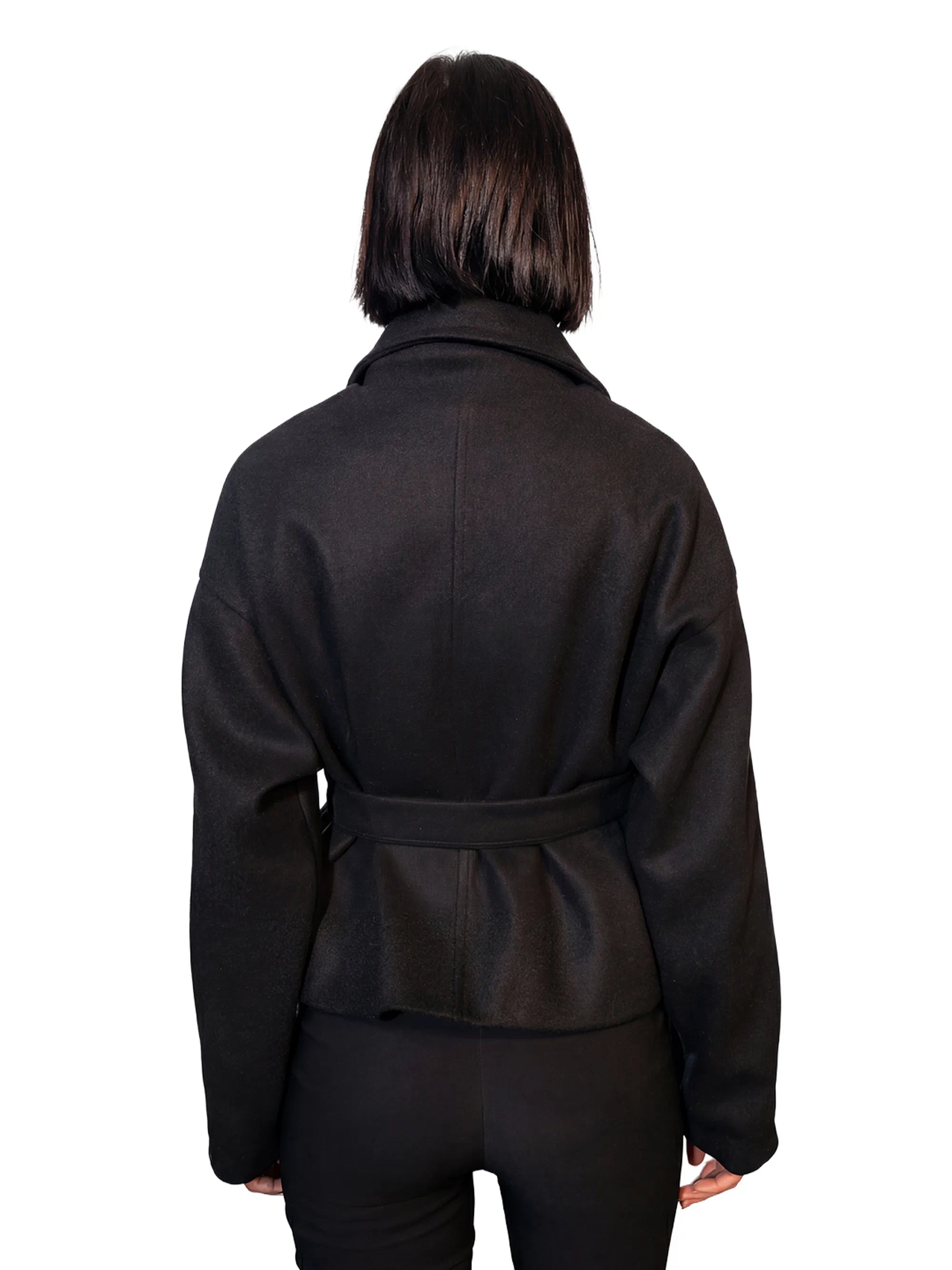 Person wearing a black jacket on a white background