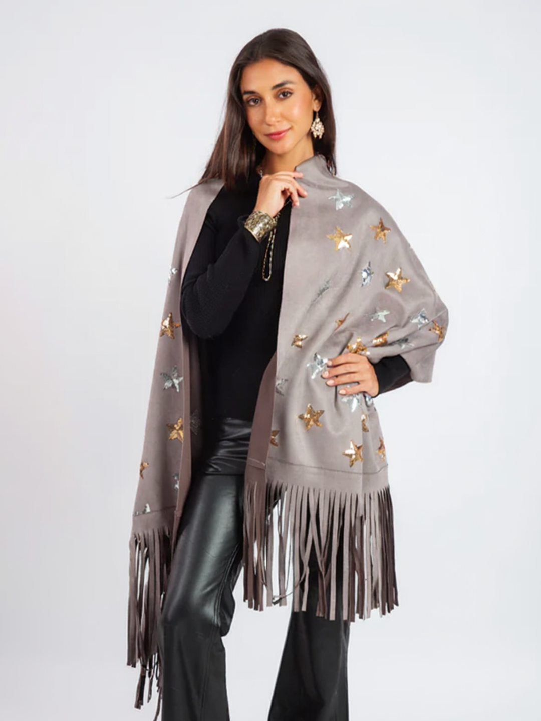 Woman wearing a gray fringe scarf with butterfly patterns on a white background