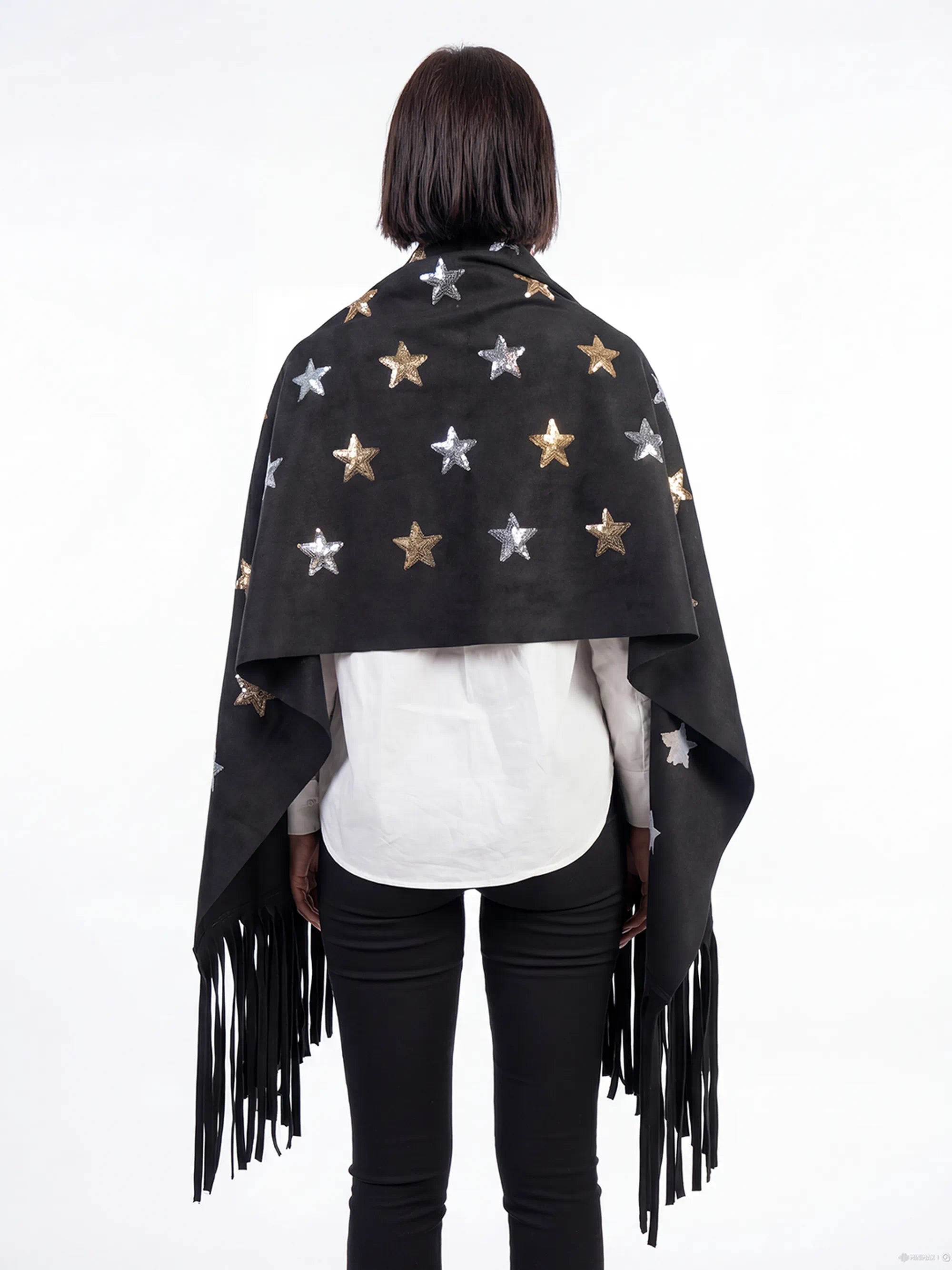 Person wearing a black star-patterned shawl with fringes on a white background