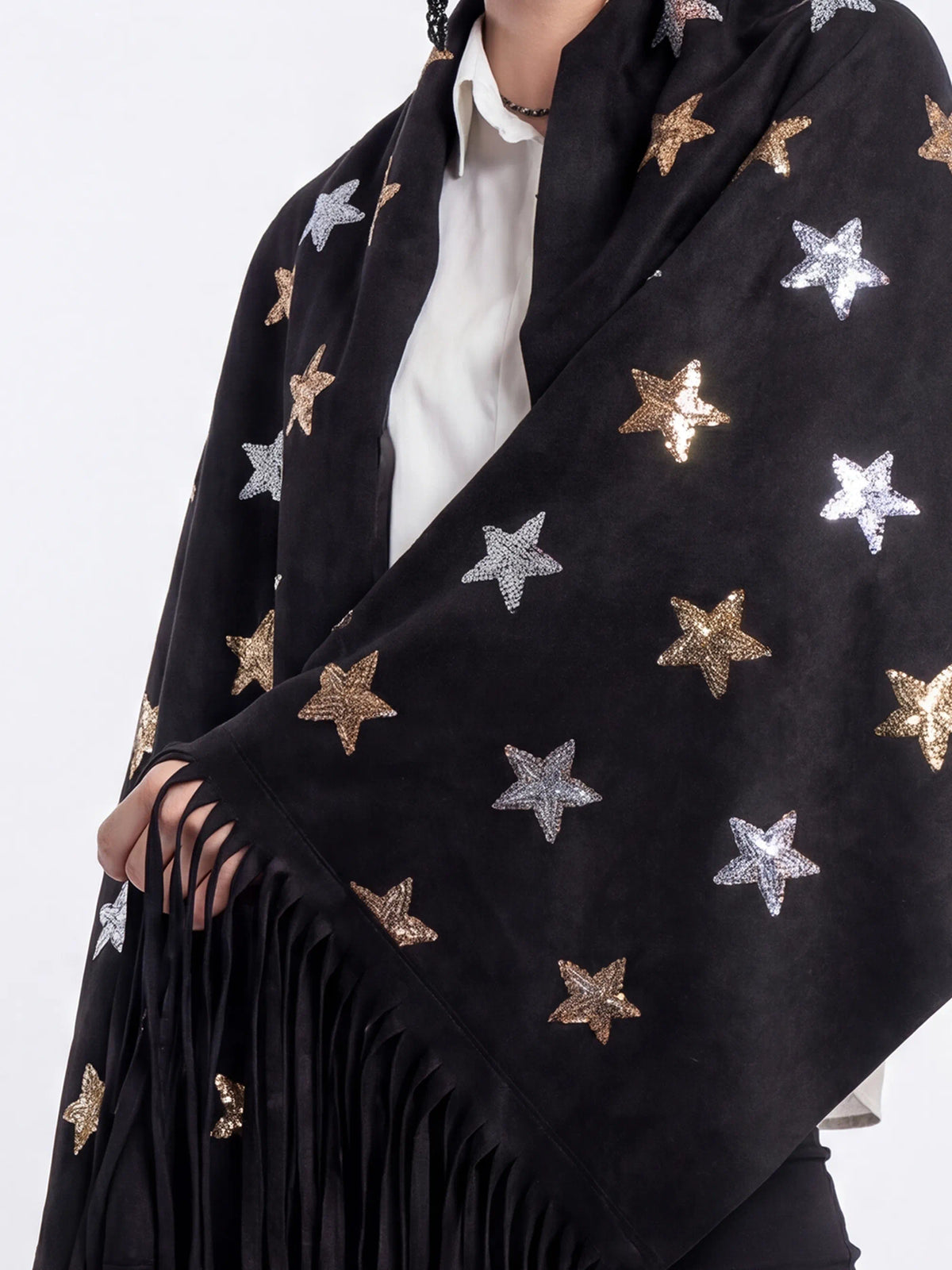 Black scarf with star patterns worn by a person on a white background